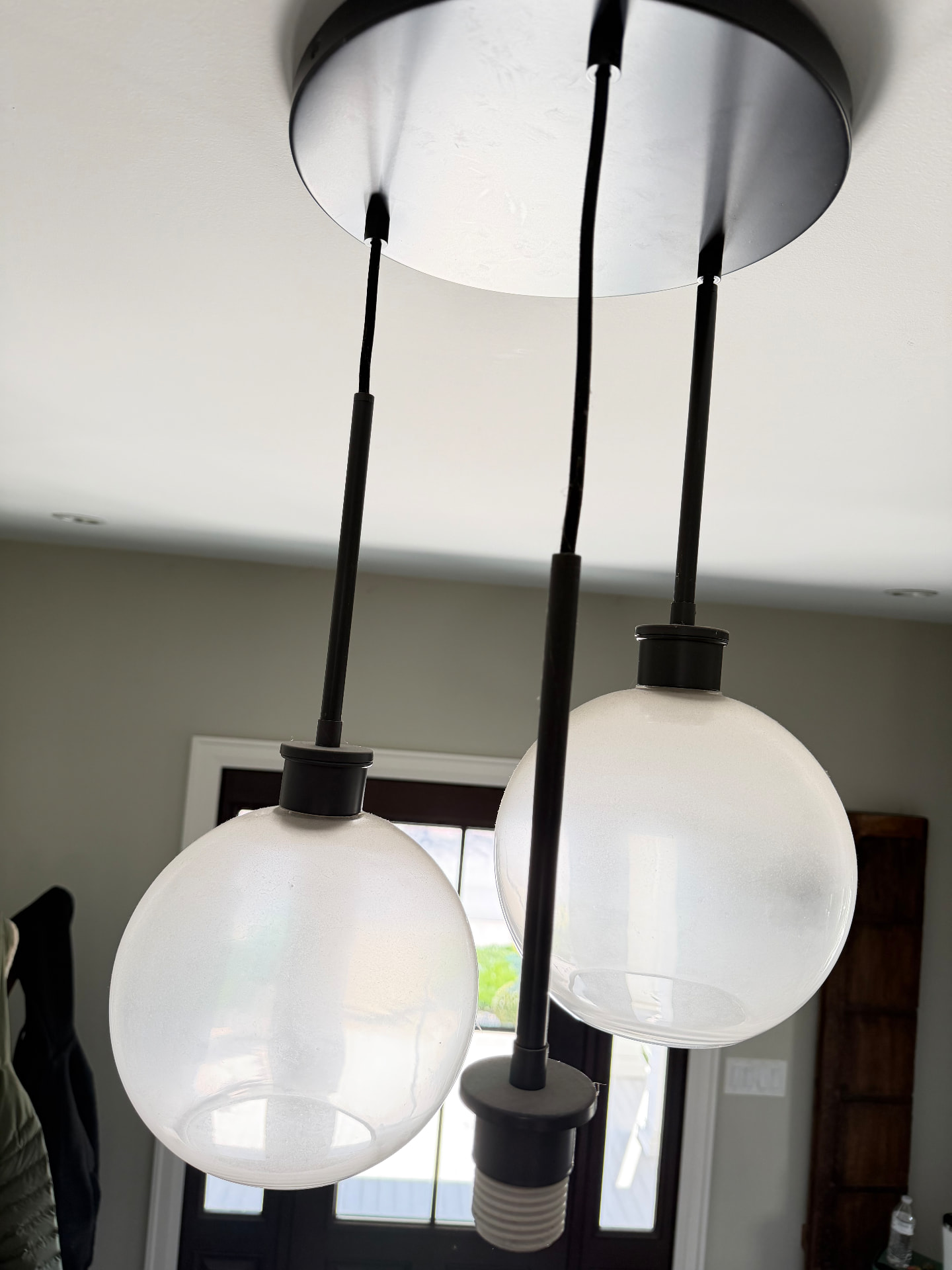 Glass pendant light shades clouded with dust before cleaning
